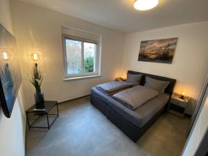 a living room with a couch and a window at Ferienhaus Deluxe in Halle an der Saale