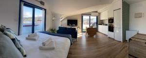 a large bedroom with a large bed and a kitchen at O Faiado by Oktheway in Puentedeume