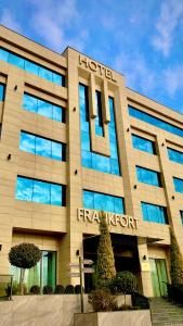 a hotel with a sign on the front of a building at Frankfort Hotel and Spa in Tashkent