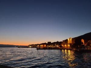 a body of water with a city at night at Apartment Aurelia in Bol +3 photos