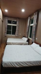 Giường trong phòng chung tại Ming Camphor Homestay
