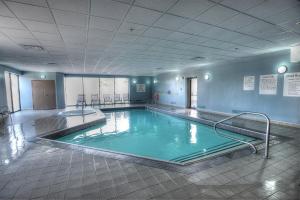 a large swimming pool in a large room at Holiday Inn Express & Suites Toronto Airport West, an IHG Hotel in Mississauga