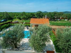 een luchtzicht op een huis met een zwembad en bomen bij Holiday home Antonia with pool in Galovac