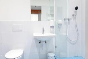 a bathroom with a toilet and a sink and a shower at Maverick Budapest Soho in Budapest