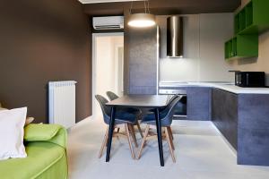 a kitchen with a table and chairs in a room at GREEN RIBBON in Milan