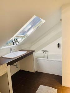 維也納的住宿－奧萊利亞豪華公寓，浴室配有盥洗盆和浴缸。