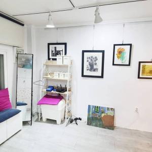 a room with a white wall with pictures on it at Solitary House in Seoul