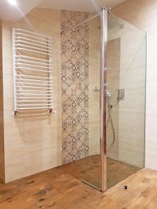 a shower with a glass door in a bathroom at Flowers in the attic in Żywiec