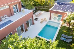 an aerial view of a house with a swimming pool at Casa dos Pinheiros 109 - Private Villa with pool & heated SPA in Porto