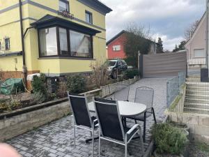 a table and chairs on a patio in front of a house at FeWo Brückweg in Bensheim