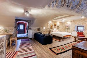 una camera con un muro in pietra e un letto e un soggiorno di Arcadia Getaway - Levidi Sani 11 Studio a Levidhion