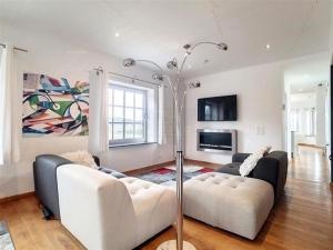 a living room with two couches and a lamp at Fietsloft - Bicycle loft in Oudenaarde