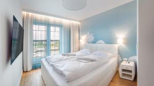 Posteľ alebo postele v izbe v ubytovaní Apartamenty Sun & Snow Port Krynica przy porcie i promenadzie