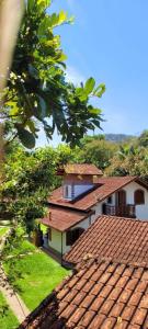 un edificio con techos de baldosas rojas y un árbol en Fazendinha Paraíso, en Lumiar
