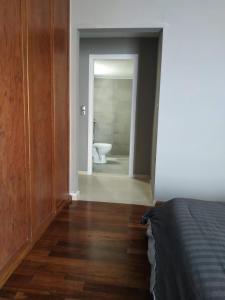 a room with a bathroom with a toilet and a bedroom at Kondylaki Apartments in Heraklio