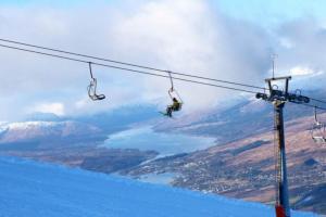 a person on a snowboard on a ski lift at The Base Camp Hotel, Nevis Range in Fort William