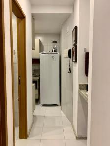 a kitchen with a white refrigerator in a room at Apto moderno e bem localizado in Recife