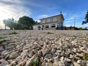 a large pile of rocks in front of a house at Casaletto's Suites in Riano