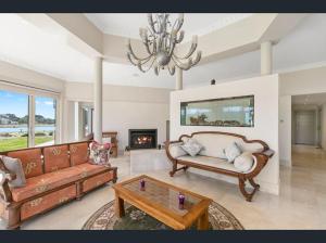 a living room with two couches and a fireplace at The Grand Manor in Pomonal