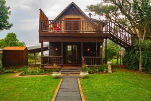 a house with a balcony and a walkway at Kangelani Lodge in Hillcrest