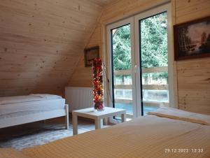 a bedroom with two beds and a vase with christmas decorations at Bystre Chaty in Bystre