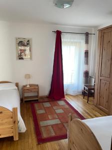 a bedroom with a bed and a red curtain at AMPAILLAN002 in Aosta