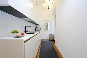a kitchen with white counters and a black ceiling at 4BNB - Serpenti Delightful Apartment in Rome