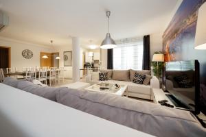 ein Wohnzimmer mit einem Sofa und einem Tisch in der Unterkunft GDE Holló Apartments in Budapest