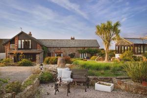 a house with a bench in front of it at Downe Cottages in Hartland