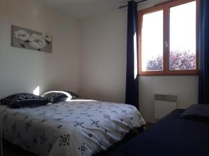 a bedroom with a bed and a window at Maison Cheptainville AVEC TERRASSE SUR VERDURE in Cheptainville