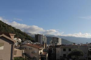 a view of a city with buildings and mountains at Apartman Bećir in Budva