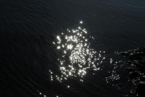 a group of lights in the water at night at Apartman Bećir in Budva