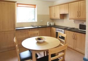 a kitchen with a table with a bowl of fruit on it at Castlewhite Apartments - UCC Summer Beds in Cork