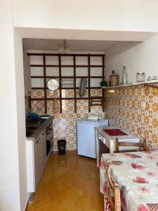 a small kitchen with a stove and a sink at Casa vacanze “La baita” in Roccaraso