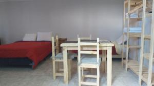 a room with a bed and a desk and bunk beds at Terra Apart Hotel in El Calafate