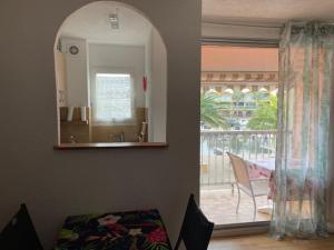 a living room with an open door to a patio at Gruissan les MARINES II in Gruissan +14 photos