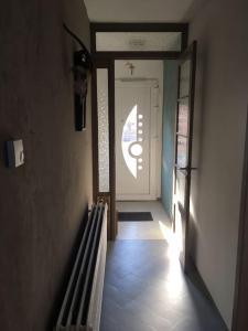 a hallway with a door and a stairway to a house at Maison cosy in Remicourt