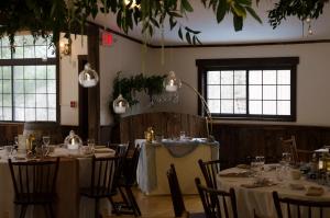 a dining room with tables with white tablecloths at Summit Lodge in Killington