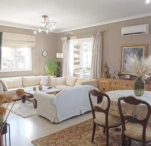 a living room with a white couch and a table at Kondylaki Apartments in Heraklio