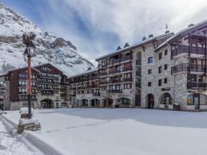 a large building with snow in front of it at Appartement luxe avec wifi et parking sur les pistes au cœur de Val-d'Isère - FR-1-694-133 in Val dʼIsère