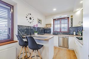a kitchen with a counter and two stools at Stella apartment in Korčula