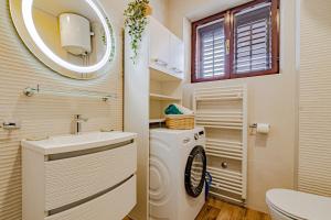 a bathroom with a washing machine and a sink at Stella apartment in Korčula