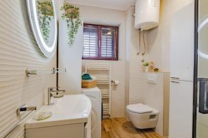a small bathroom with a sink and a toilet at Stella apartment in Korčula