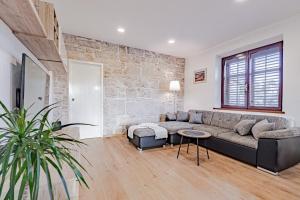 a living room with a couch and a table at Stella apartment in Korčula