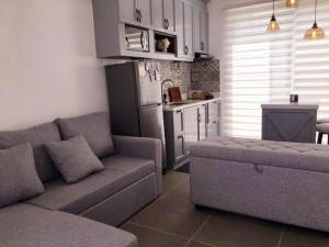 a living room with a couch and a kitchen at Cozy Holiday Home at Batulao Artscapes 2Br brand new fully airconditioned in Calo