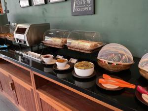 a buffet line with pies and other food on a counter at Avatar Railay in Railay Beach