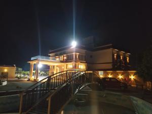 a building with a bridge in front of it at night at Flamingo Club and Resort Una 3 Km Away from Diu Check Post in Diu