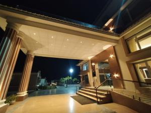 a large house with stairs and a balcony at night at Flamingo Club and Resort Una 3 Km Away from Diu Check Post in Diu
