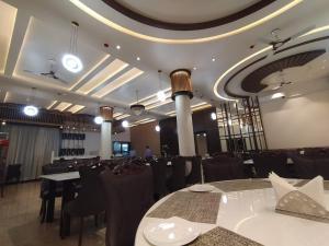 a banquet hall with tables and chairs in a room at Flamingo Club and Resort Una 3 Km Away from Diu Check Post in Diu