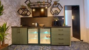a green cabinet with glass doors in a room at ART - Balcescu in Sibiu